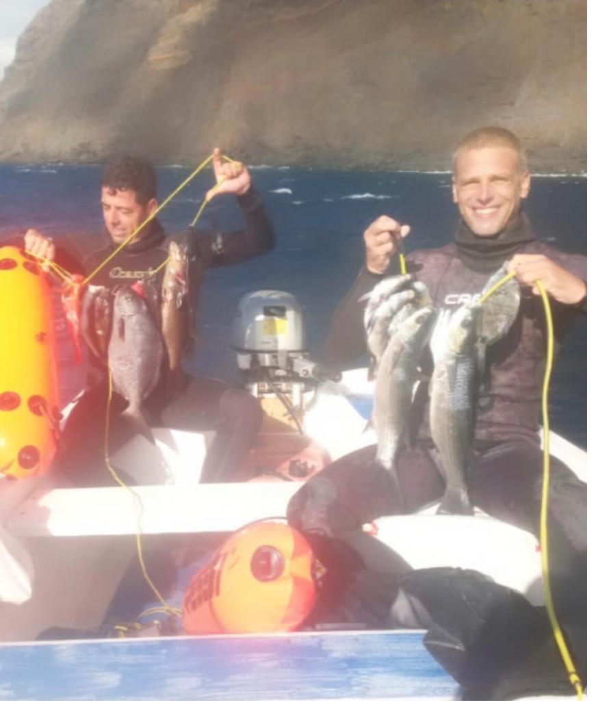 Two hunters in boat with catch after blue water trip